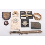 A WWII period miniature RAD dagger letter opener, in scabbard, a NSDAP badge,