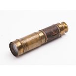 A 19th Century brass and leather bound three draw telescope. Unsigned, 15cm long (closed).