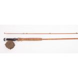 An early 20th Century two piece fly fishing rod fitted with a 3' brass reel.