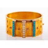 A Victorian Persian style unmarked yellow metal, seed pearl and turquoise cuff bangle,