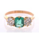 A Victorian emerald and diamond three stone ring, with an octagonal cut emerald of good colour,