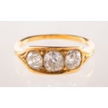 An antique three stone diamond ring, set with three old-cut diamonds,