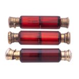 A late 19th/ early 20th century silver-gilt mounted red cut-glass scent bottle,