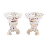 A pair of Meissen porcelain salts set on three scrolling feet and enamelled with deer and exotic