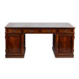 A fine walnut pedestal desk in Regency style,