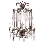 A patinated metal and glass hung eight -light 'cage' chandelier in lantern form,
