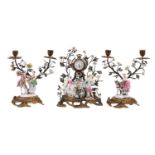 A late 19th century ormolu and porcelain-mounted clock garniture with twin-branch side pieces,