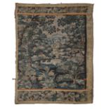 A 17TH CENTURY VERDURE TAPESTRY DEPICTING A FOLIATE SCENE OF A CLEARING IN A FOREST.