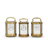 A collection of three early 20th-century oval-shaped French carriage clocks
