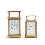 A late 19th century French striking carriage clock and a mid 19th century one piece cased carria...