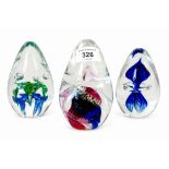 Murano style egg shaped art glass paperweights featuring controlled bubbles, interior inclusions