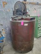 Lubricant dispensing barrel with hose reel mounted to top.