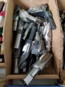 Large assortment of end mills, drills, and taps.