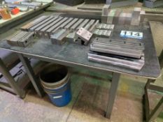 Table with Machined Metal Blocks and Parts Assortment