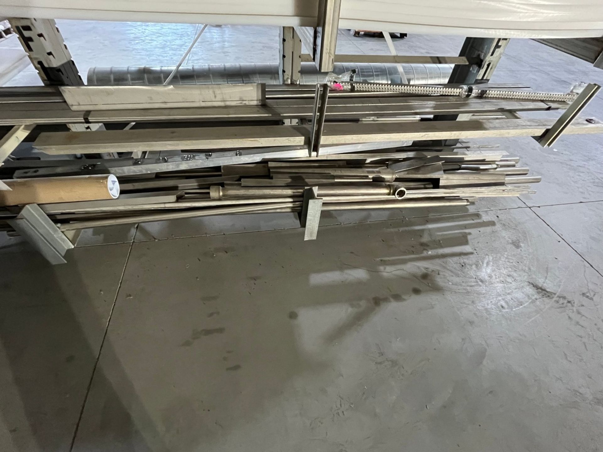 Material on Cantilever Rack Facing Blasting Booth (MATERIAL ONLY, RACK)