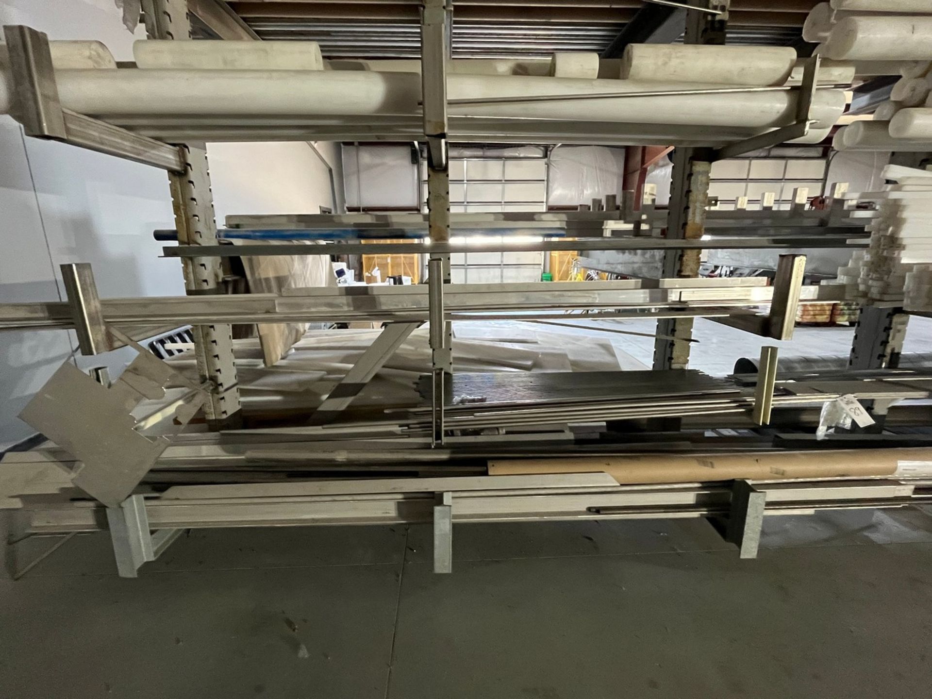 Material on Cantilever Rack Facing Blasting Booth (MATERIAL ONLY, RACK)