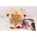 A large creamy white bear with black plastic nose and plastic eyes,