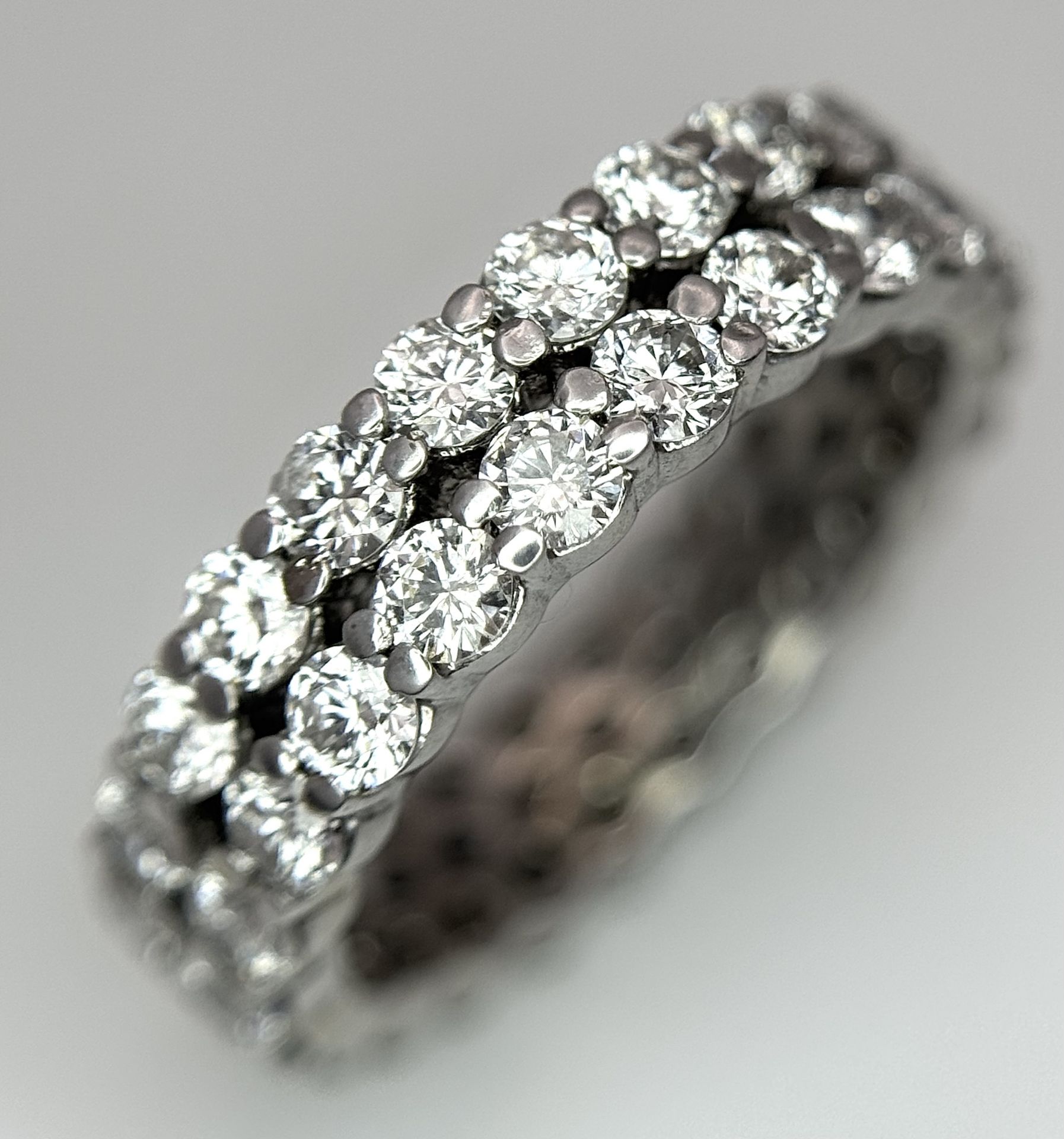 AN 18K WHITE GOLD TWO ROW DIAMONDS SET ETERNITY RING, 4.7 GR, SIZE J ...