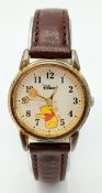 AN EXCLUSIVE DISNEY, WINNIE THE POOH, BROWN LEATHER STRAP WATCH. HONEY POT IS THE MINUTE HAND AND