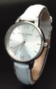 AN OLIVIA BURTON LONDON, WHITE LEATHER STRAP WATCH. IN FULL WORKING ORDER. AS NEW. S/A 1555