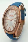 A FOLLI FOLLIE, ROSE GOLD TONE, STPONE SET, BLUE LEATHER STRAP WATCH. IN FULL WORKING ORDER. NEW