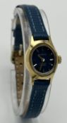 AN EVERITE, GOLD TONE, MANUAL WIND, BLUE DIAL AND LEATHER STRAP WATCH. IN WORKING ORDER. S/A 131