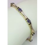 A Stylish Sterling Silver and Tanzanite Set Tennis Bracelet- 19cm Length. Set with Ten 6 x 4mm