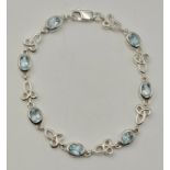 A Pretty Sterling Silver, Celtic Knot Design, Blue Topaz Set Tennis Bracelet-17cm Length. Set with