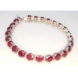 A Ruby Gemstone Tennis Bracelet set in 925 Silver with Diamond Accents. Ruby weight approx 12ctw,