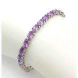 An Eye-Catching Sterling Silver and Amethyst Set Tennis Bracelet- 19cm Length. Set with Twenty-
