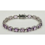 An Attractive Sterling Silver and Large Amethyst Set Tennis Bracelet-19.5cm Length. The Bracelet