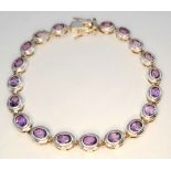 A Stylish Sterling Silver and Amethyst Set Tennis Bracelet-19.5cm Length. Set with nineteen 5 x