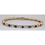 A 14K Yellow Gold Sapphire and Diamond Tennis Bracelet. 18cm length. 3ctw of oval cut sapphires