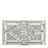A Platinum 3.0ct Diamond Brooch. With an intricate openwork design, this luxury brooch draws