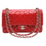 A Chanel Red Patent Leather Classic Double Flap Bag. Red leather exterior with silver-toned