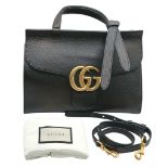 A Gucci GG Marmont Black Leather Top Handle Bag. Black leather exterior with gold-toned hardware,