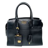 A Prada Black Saffiano Leather Tote Bag. Black Saffiano and smooth leather exterior with gold-