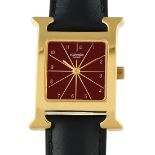 A Hermes Heure H Red Dial Gold Plated Steel Quartz Watch, ref. HH1.201. H-shaped case with a red