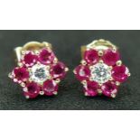A Pair of 18K Gold Ruby and Diamond Stud Earrings. Centre diamond with ruby surround. 2.4g total