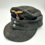 A WW2 German Luftwaffe M43 Field Cap. Dark blue grey wool with a two button closure and Eagle/