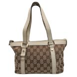 A Gucci Monogram Small Abbey Tote Bag. Beige and brown GG monogram canvas exterior with cream