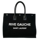 A Saint Laurent Rive Gauche Tote Bag. Black linen canvas exterior with white "Rive Gauche Saint