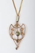 An Edwardian peridot and yellow metal pendant on 9ct chain, the pendant 18mm wide, 2.8g