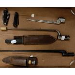 A bowie style knife, 32 cm, with a leather scabbard, three bayonets, a sheath knife, and two folding
