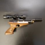 A Titan .22 air pistol, with a Bushmaster 2.5 x 32 scope    Provenance: The property of a lifetime