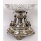 An impressive Edwardian silver and cut glass table centrepiece, of oval form, the base with two lady