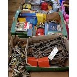 Assorted new old stock, including bulbs, spark plugs, exhaust clamps, a group of assorted books, O