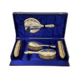 A silver-backed five-piece hairbrush and mirror set, Birmingham, 1939, initialled, the case 39cm