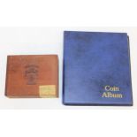 A vintage coin album and contents containing mostly British coins and a vintage wooden cigar box