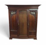 An Art Nouveau three section wardrobe, the side do
